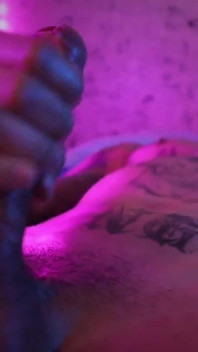 Un caldo ragazzo tatuato si masturba il suo grosso cazzo non circonciso con l'olio e spara il suo sperma