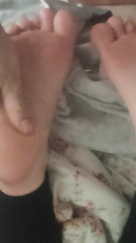 Playing with Friends Soles, While She's Reading.