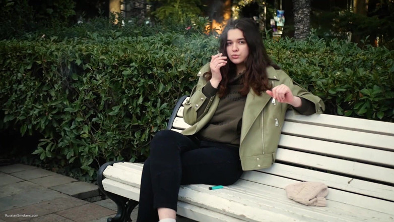 Russian Smokers: Joven morena está dando un paseo sin prisas con cigarrillo...