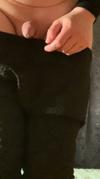 A Crossdresser in Leggings and a Seductive Bodysuit Plays with Ass
