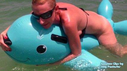 Brittany Lynn: Humping blue inflatable toy in the water at a beach...