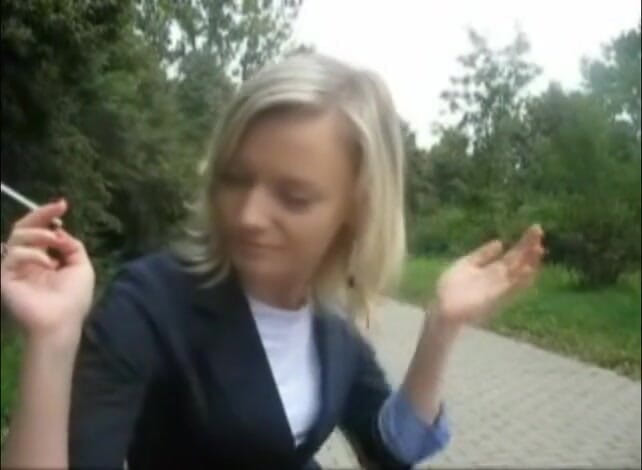Femdom Austria: Blonde beauty smoking a cigarette outdoors