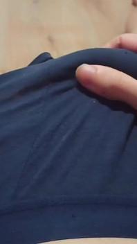 A Young Athletic Guy in Blue Shorts Is Massaging His Penis