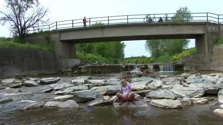 Femdom Austria: Blonde pissing outside in a river