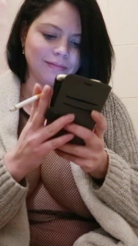 Une MILF enceinte fume une cigarette