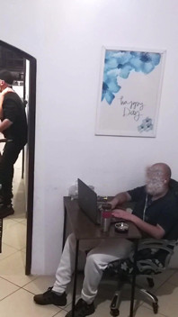 While the Husband Works, the Wife in a Towel Greets the Delivery Man