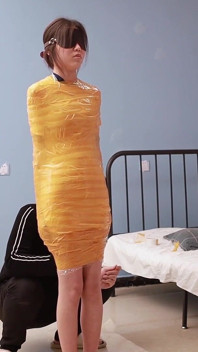 A Cute Barefoot Girlfriend Uses Tape to Bind Her Whole Body, Playing with Her Cute Bare Feet