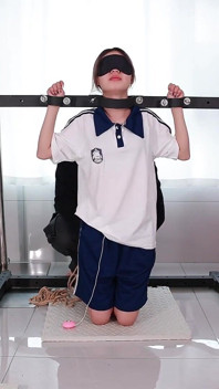 A Girl with a Metal Gag in Place, Playing with Her Tongue