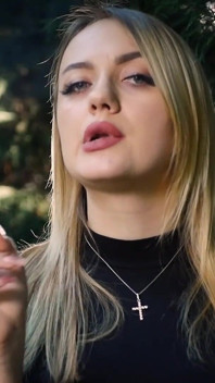 Quente loira gata fumando um cigarro preto na natureza