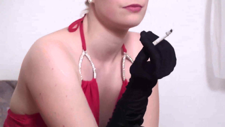Femdom Austria: Classy blonde wearing glasses smoking a cigarette