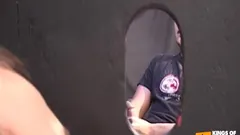 Young dude masturbates and cums in a guy's mouth through glory hole