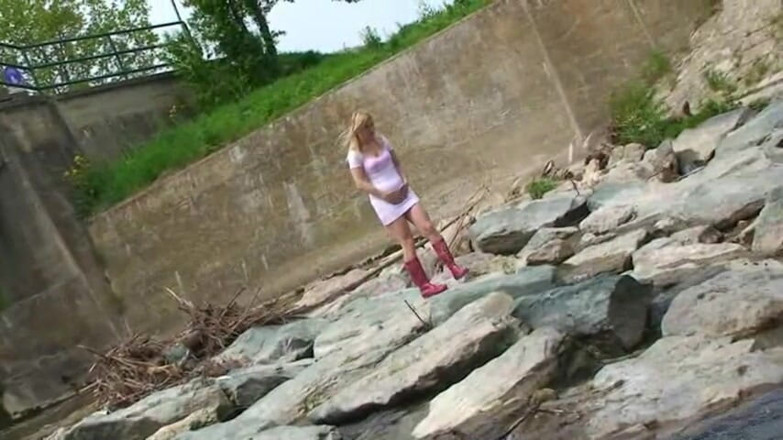 Femdom Austria: Blonde pissing outside in a river