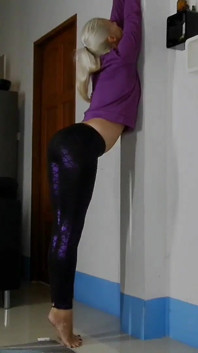 Sensual Wall Stretching in Shiny Purple Leggings