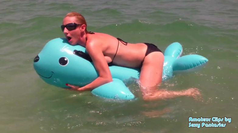 Brittany Lynn: Humping blue inflatable toy in the water at a beach...