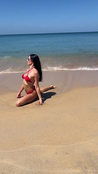 Teasing in Red Bikini on the Beach