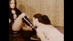 Vintage megastore: Lesbian Mistress in Leather Dress and Black Boots Dominating a...