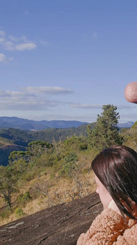 Tour Guide Shows Stick to Tourist on Mountain