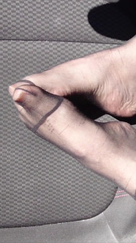 Feet of Nylonjunge in Pantyhose in Car