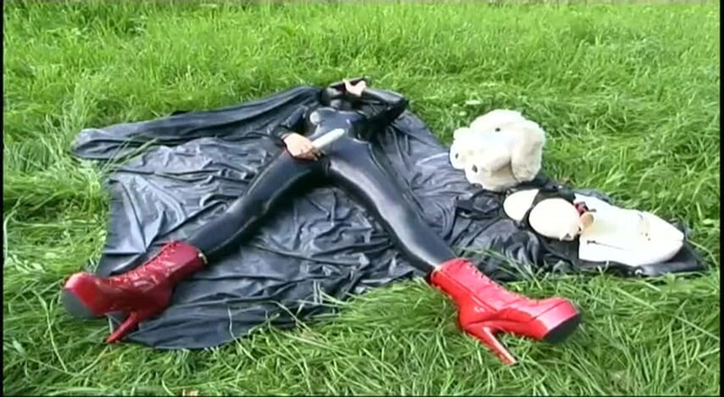 Fetish Desire: Fetish slave in latex walks and sucks a dildo on...