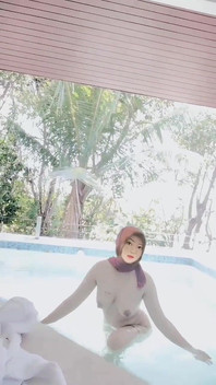 Hijab-wearing Woman Bathes Naked in an Open Swimming Pool
