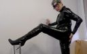 Mature cunt: PVC catsuit and shiny boots posing
