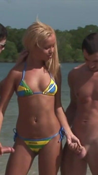 Sexy blonde fucked in the waters of a tropical river by two handsome hunks