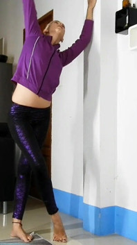 Sensual Wall Stretching in Shiny Purple Leggings