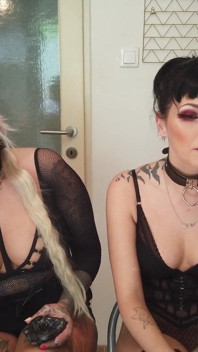 Tattooed ladies smoking in the kitchen