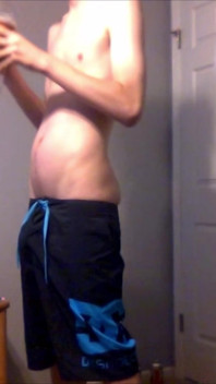 Young Guy Fills His Stomach with Water