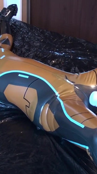 Latex Danielle is attached to the bed and masturbated with the massage vibrator