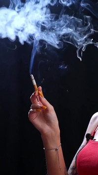 Sexy Lady in Red Is Smoking Two 100mm Reds