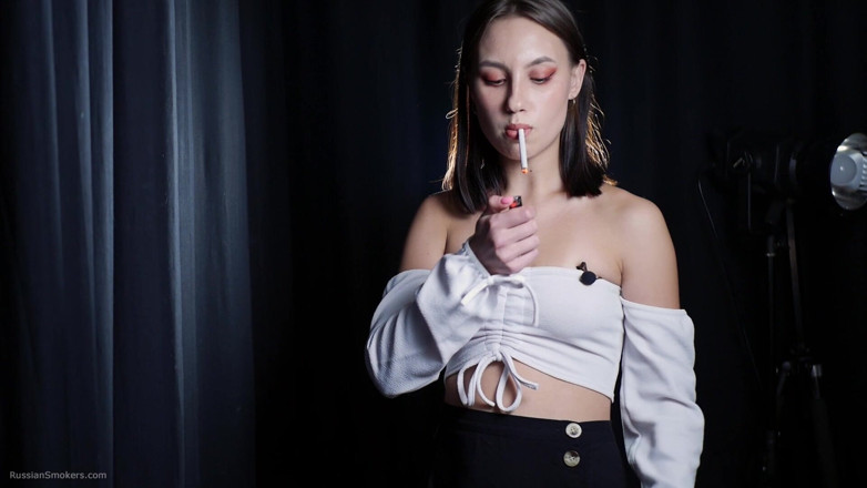 Russian Smokers: Elegant Brunette Smoking Cigarette in Dark Studio Scene