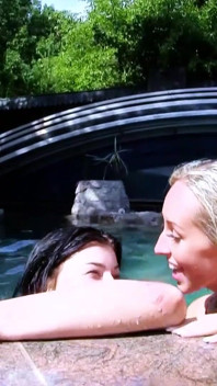 Two horny lesbians masturbate with toys outdoor by the pool