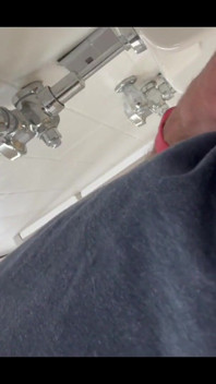 Pissing at a urinal with no dividers.