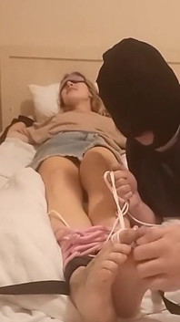 Solletico i miei piedi con le manette e una benda