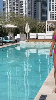 Monika Fox Poses in Pink Bikini and Swims in Pool Surrounded by Skyscrapers
