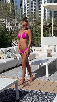 Monika Fox Poses in Pink Bikini and Swims in Pool Surrounded by Skyscrapers