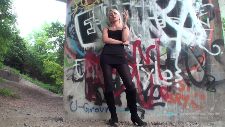 Femdom Austria: Lovely blonde teen smoking a cigarette outdoors