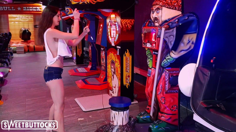 SweetButtocks: Hot teen in a short skirt is playing machine guns...