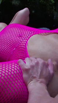 Stunning babe in fishnet gets fingered and fucked outdoors