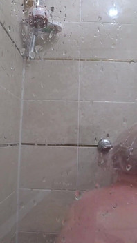 The camera is watching a mature chubby milf in the shower. Gorgeous fat ass, big natural boobs, hairy pussy. PAWG.