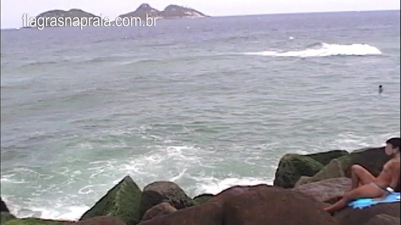 Amateurs videos: I filmed a woman doing topless on the rocks near...