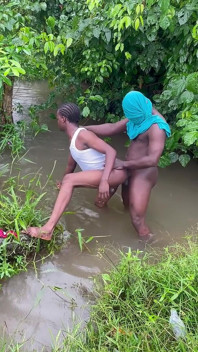 Sex Inside a Swampy River Rounded by Wild Bushes