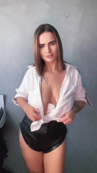 A Brunette in a White Shirt Is Ready to Bare Her Big Breasts