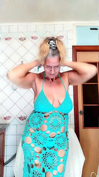 Striptease engraçado de uma dona de casa quente na cozinha