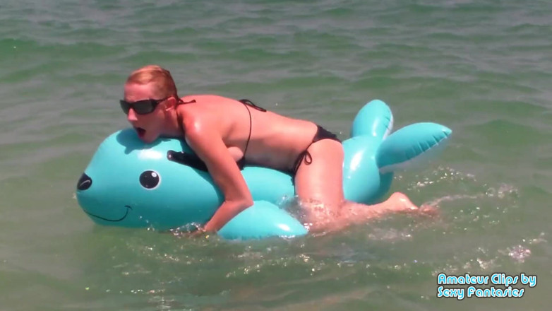 Brittany Lynn: Humping blue inflatable toy in the water at a beach...
