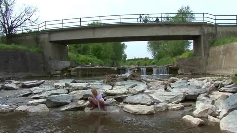 Femdom Austria: Blonde pissing outside in a river