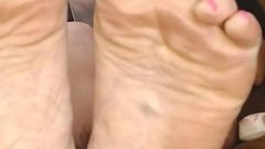 Busy Little MILF Has Her Soles in Your Lap