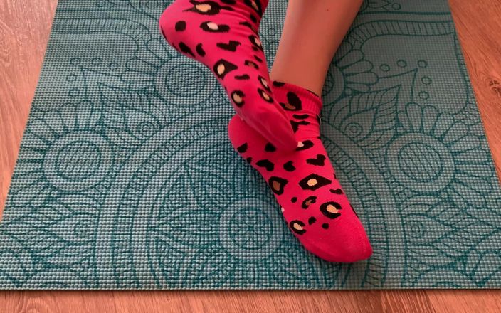 Gloria Gimson: Спортивная девушка делает упражнения для ног в розовых носках на коврике для йоги