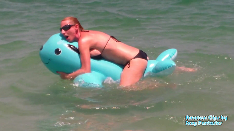 Brittany Lynn: Humping blue inflatable toy in the water at a beach...